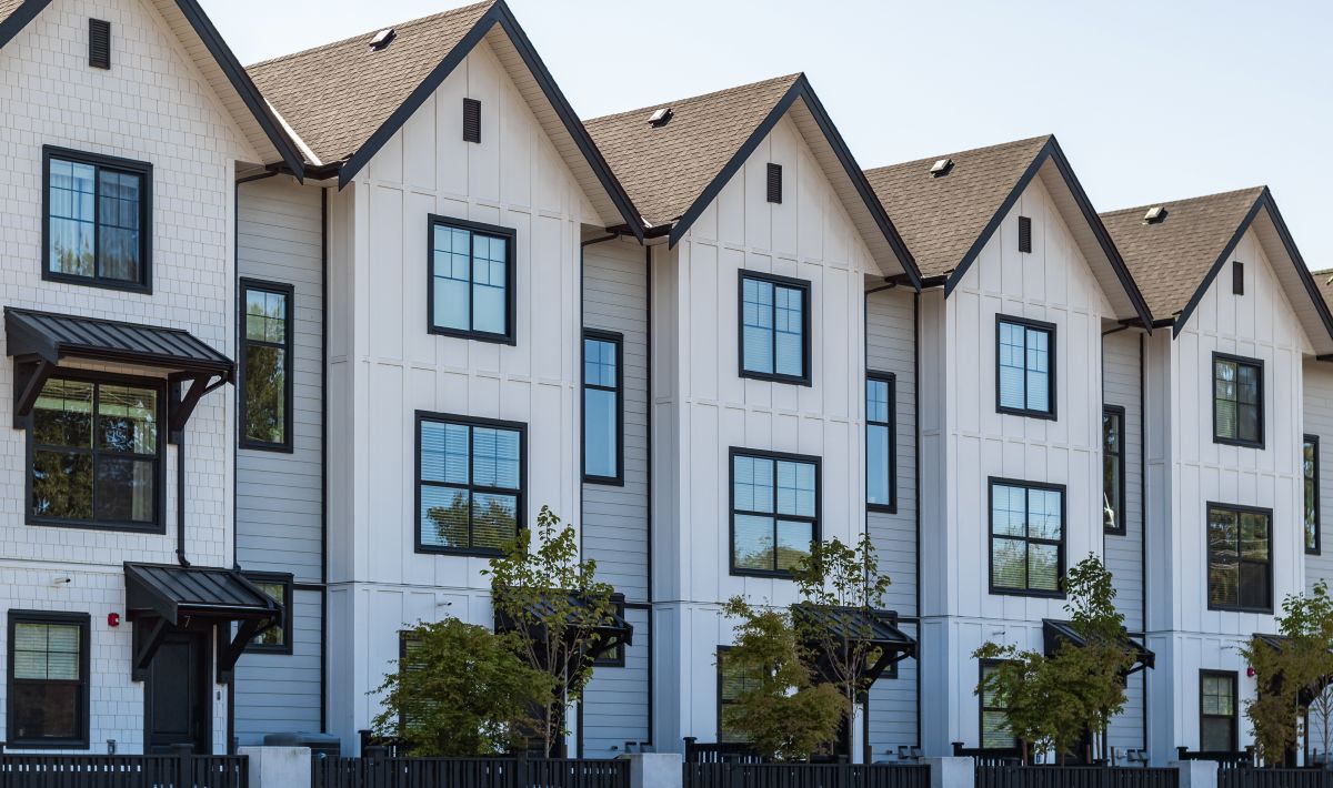 Apartment buildings with brown shingle roof, in Woodbury